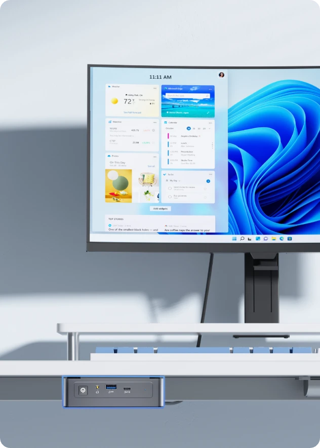 GEEKOM AIR12 mini PC connected to monitor in modern desk setup running Windows 11